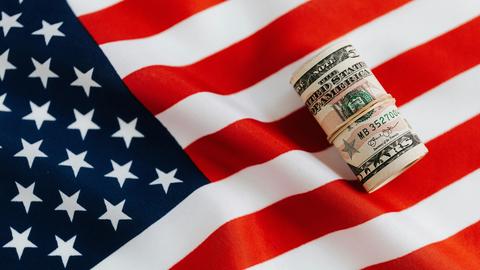 United States flag and a roll of money